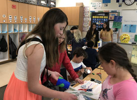 third grade students working with middle school student